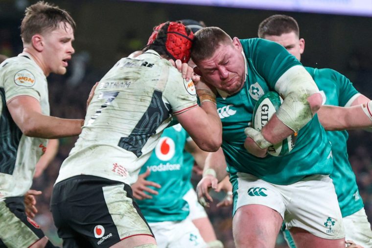 TOPSHOT - Ireland's prop Tadhg Furlong (R) is tackled by Wales' flanker James Botham (2L) during the Six Nations international rugby union match between Ireland and Wales at the Aviva Stadium in Dublin, on March 6, 2026. (Photo by Paul Faith / AFP via Getty Images)