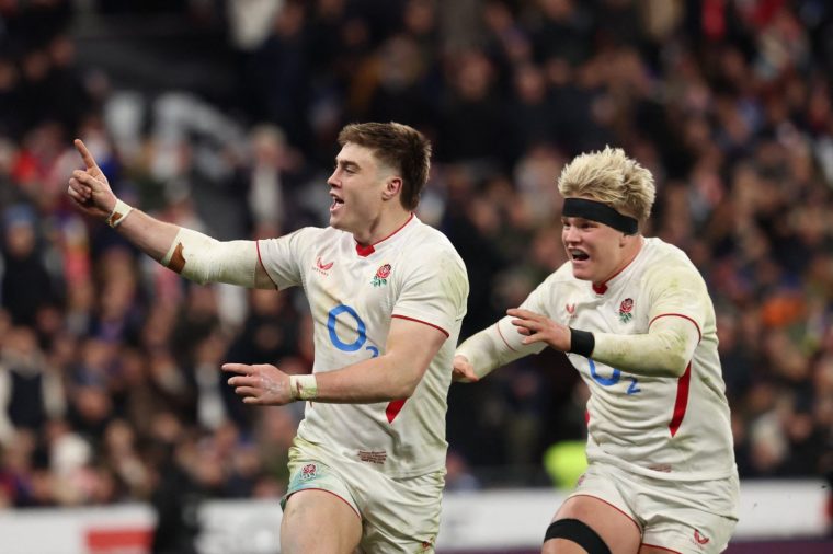 England's wing Tommy Freeman (L) celebrates with England's number 8 Henry Pollock (R) after scoring England's seventh try during the Six Nations international rugby union match between France and England at the Stade de France, in Saint-Denis, north of Paris, on March 14, 2026. (Photo by FRANCK FIFE / AFP via Getty Images)