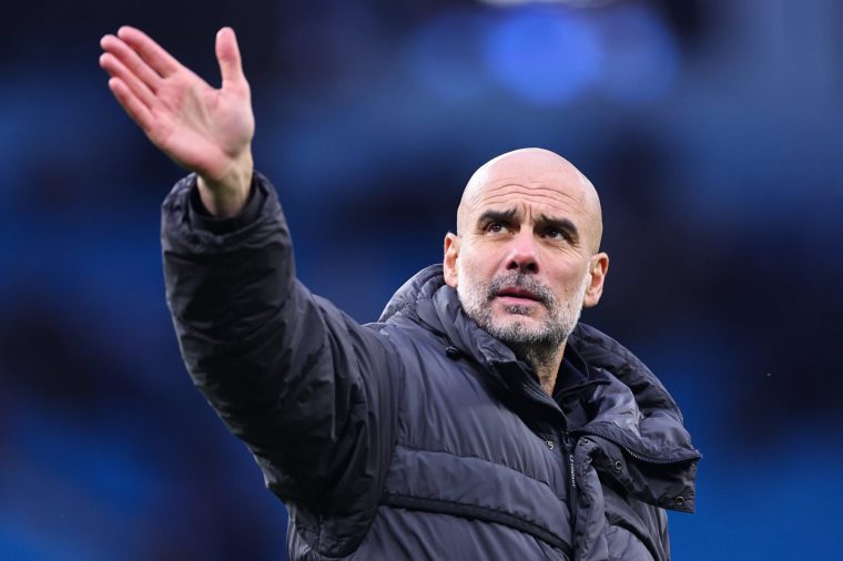 MANCHESTER, ENGLAND - FEBRUARY 14: Pep Guardiola Manager / Head Coach of Manchester City waves to the fans at full time during the Emirates FA Cup Fourth Round match between Manchester City and Salford City on February 14, 2026 in Manchester, England. (Photo by Robbie Jay Barratt - AMA/Getty Images)