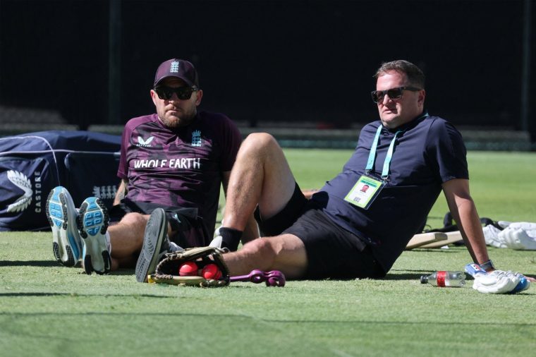 (FILES) England's Managing Director of Cricket Rob Key (R) and head coach Brendon McCullum (L) relax during team's training session at The Gabba in Brisbane on December 2, 2025, ahead of the second Ashes cricket Test. England captain Ben Stokes, head coach McCullum, and England managing director Rob Key are all set to keep their jobs following a review of the Ashes campaign by the England and Wales Cricket Board. (Photo by DAVID GRAY / AFP via Getty Images) / -- IMAGE RESTRICTED TO EDITORIAL USE - STRICTLY NO COMMERCIAL USE --