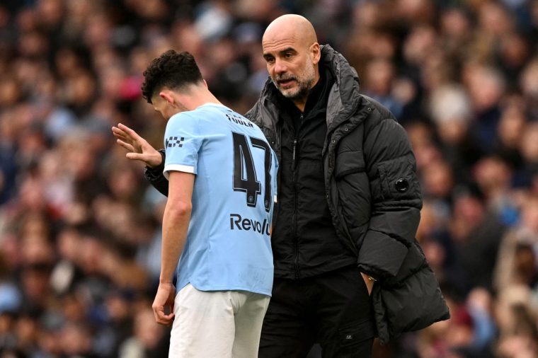 Manchester City's Spanish manager Pep Guardiola talks to Manchester City's English midfielder #47 Phil Foden during the English FA Cup third round football match between Manchester City and Salford City at the Etihad Stadium in Manchester, north west England, on February 14, 2026. (Photo by Oli SCARFF / AFP via Getty Images) / RESTRICTED TO EDITORIAL USE. No use with unauthorized audio, video, data, fixture lists, club/league logos or 'live' services. Online in-match use limited to 120 images. An additional 40 images may be used in extra time. No video emulation. Social media in-match use limited to 120 images. An additional 40 images may be used in extra time. No use in betting publications, games or single club/league/player publications. /