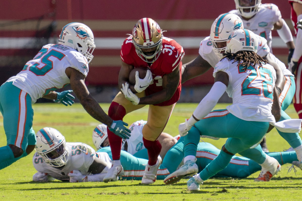 San Francisco 49ers running back Raheem Mostert attempts to rush with the ball against Miami Dolphins.