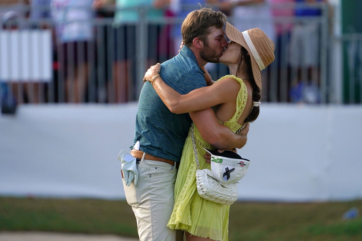 Sam Burns kisses his wife Caroline Burns