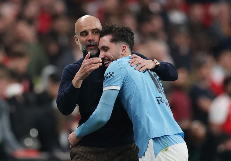 Soccer Football - Carabao Cup - Final - Arsenal v Manchester City - Wembley Stadium, London, Britain - March 22, 2026 Manchester City's Rayan Cherki embraces manager Pep Guardiola as he is substituted off Action Images via Reuters/Paul Childs EDITORIAL USE ONLY. NO USE WITH UNAUTHORIZED AUDIO, VIDEO, DATA, FIXTURE LISTS, CLUB/LEAGUE LOGOS OR 'LIVE' SERVICES. ONLINE IN-MATCH USE LIMITED TO 120 IMAGES, NO VIDEO EMULATION. NO USE IN BETTING, GAMES OR SINGLE CLUB/LEAGUE/PLAYER PUBLICATIONS. PLEASE CONTACT YOUR ACCOUNT REPRESENTATIVE FOR FURTHER DETAILS..