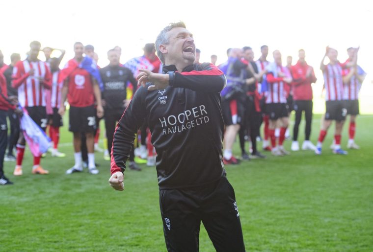 READING, ENGLAND - APRIL 6: Michael Skubala, head coach of Lincoln City celebrates promotion following the Sky Bet League One match between Reading and Lincoln City at Select Car Leasing Stadium on April 6, 2026 in Reading, United Kingdom. (Photo by Andrew Vaughan/Getty Images)