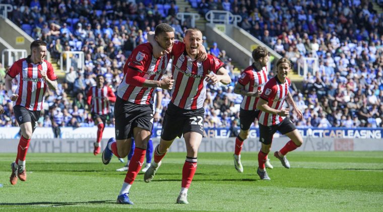 READING, ENGLAND - APRIL 6: Ryan One of Lincoln City, left, celebrates scoring the opening goal with team-mate Tom Hamer during the Sky Bet League One match between Reading and Lincoln City at Select Car Leasing Stadium on April 6, 2026 in Reading, United Kingdom. (Photo by Chris Vaughan/Getty Images)