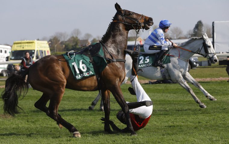 Mr David Maxwell gets his leg caught in the reins after falling off his horse Joker De Mai at The Chair fence in the Randox Foxhunters Open Hunters' Steeplechase on day one of the Grand National meeting at Aintree Racecourse on April 3rd 2025 in Liverpool (Photo by Tom Jenkins/Getty Images)