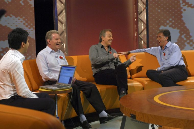 Prime Minister Tony Blair enjoys a joke while appearing on Football Focus, 05/11/2005, with (from left) presenter Manish Bhasin and pundits / commentators John Motson and Mark Lawrenson. Joke joking laugh laughing. (Photo by Jeff Overs/BBC News & Current Affairs via Getty Images)