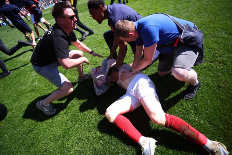 Soccer Football - National League - Rochdale v York City - Spotland Stadium, Rochdale, Britain - April 25, 2026 York City's Josh Stones celebrates scoring their first goal with fans who invaded the pitch Action Images/Ed Sykes