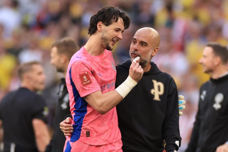 LONDON, ENGLAND - APRIL 25: James Trafford of Manchester City with Pep Guardiola head coach / manager of Manchester City after the Emirates FA Cup Semi Final match between Manchester City and Southampton on April 25, 2026 in London, England. (Photo by Marc Atkins/Getty Images)
