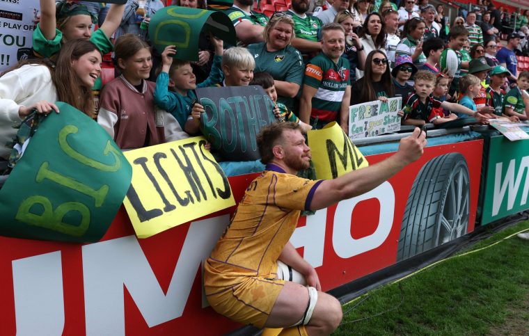 LEICESTER, ENGLAND - MAY 09: Callum Chick of Northampton Saints poses for a selfie with supporters after the Gallagher PREM match between Leicester Tigers and Northampton Saints at Mattioli Woods Welford Road Stadium on May 09, 2026 in Leicester, England. (Photo by David Rogers/Getty Images)