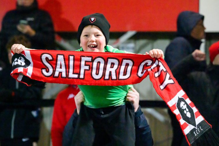 A young Salford City fan celebrates during the Emirates FA Cup Third Round match between Salford City and Swindon Town at The Peninsula Stadium in Salford, on January 20, 2026. (Photo by Ian Charles/MI News/NurPhoto via Getty Images)